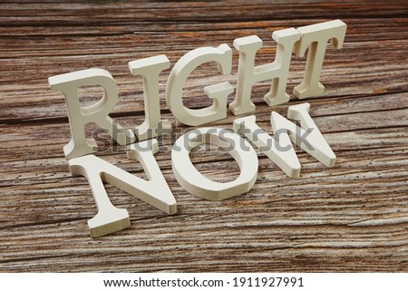 Right Now Word alphabet letters on wooden background