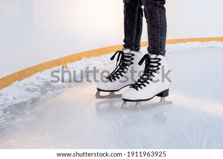 children's feet in skates on the ice rink