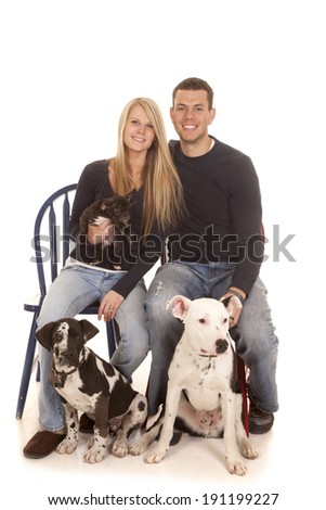 a family photo of a man and wife with all their dogs.
