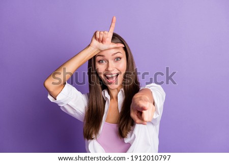 Photo of funky excited young girl finger forehead direct you open mouth wear white shirt isolated purple color background