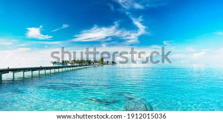 Beautiful landscape with bridge to pier. Color fusion of ocean and sky. Light ripples on amazingly clear water. Perspective receding into distance. Image fine vacation on summer. Relax and rest.