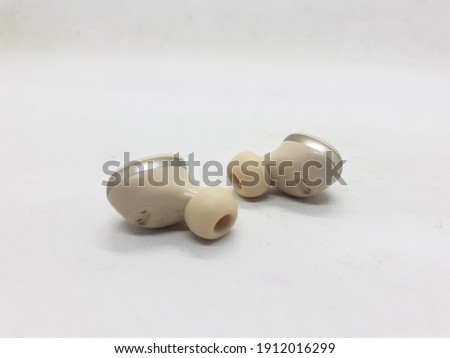 Electronic Wireless Ear Phone in White Isolated Background
