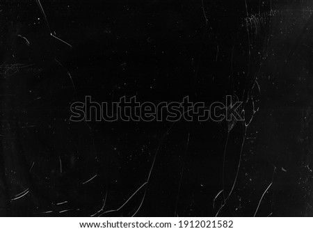 Fractured overlay. Broken screen. Dark smashed shattered laptop glass with dust scratches stains grain noise grunge effect mask.