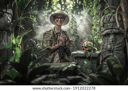 Brave woman exploring the jungle and taking pictures with her camera, she finds ancient ruins and a human skull