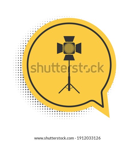 Black Movie spotlight icon isolated on white background. Light Effect. Scene, Studio, Show. Yellow speech bubble symbol. Vector.