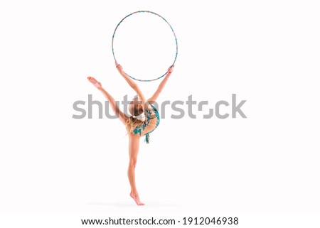gymnast girl in an emerald swimsuit performs an exercise with a hoop isolated on white background