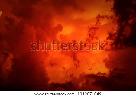 Fantastic concept mystical horror background from another planet from the paranormal world, fantasy style. Dramatic red black orange sky with scary hellish clouds and terrible shadows and light Royalty-Free Stock Photo #1912071049