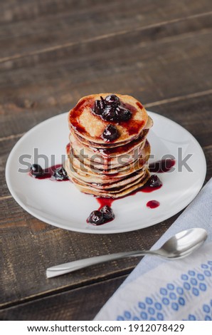 Delicious pancakes with cherry jam, soft focus. 