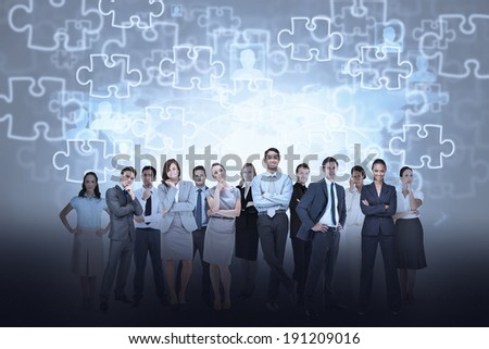 Digital composite of business team against jigsaw background