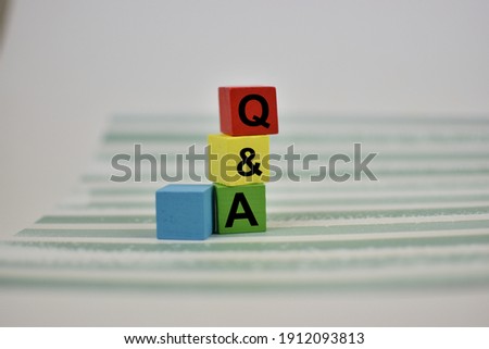 wooden block with the abbreviation Questions and Answers