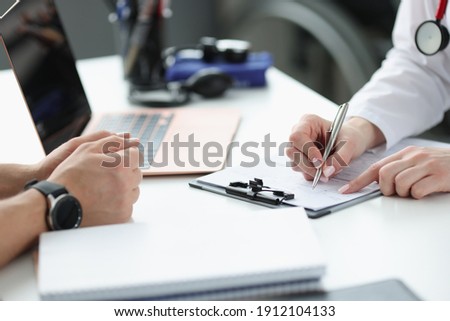 Doctors hands writing down patients complaints in medical history closeup. Medical consultation concept Royalty-Free Stock Photo #1912104133