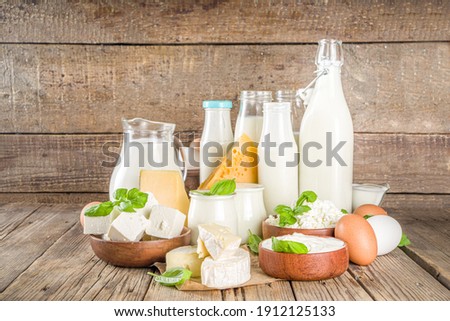 Set of Various Fresh Dairy Products - milk, cottage cheese, cheese, eggs, yogurt, sour cream, butter on wooden background Royalty-Free Stock Photo #1912125133