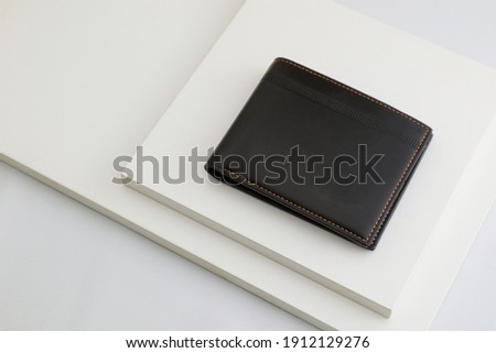 Fashionable black leather men's wallet on white background  