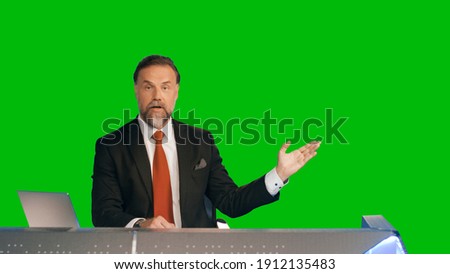 Green Screen Background: Live News Studio with Professional Male Anchor Reporting on the Events of the Day. Television Channel Newsroom Concept. Chroma Key Template Background Royalty-Free Stock Photo #1912135483