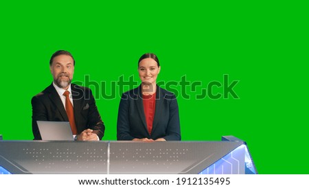 Green Screen Background: Live News Studio with Beautiful Female and Handsome Male Anchors Reporting on the Events of the Day. Television Channel Newsroom Concept. Chroma Key Template Background