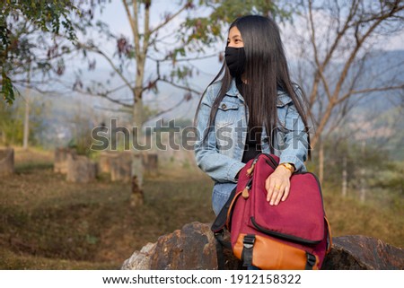 Asian woman tourist wearing face mask. Coronavirus flu virus travel concept 
