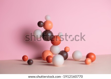 Modern composition with pastel round objects. Minimalistic geometric balls on pink and beige background. Still life with harmony and balance concept.
