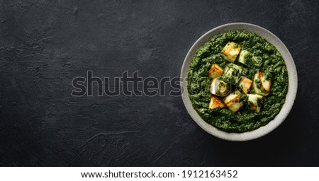 Palak Paneer on black background, top view Royalty-Free Stock Photo #1912163452