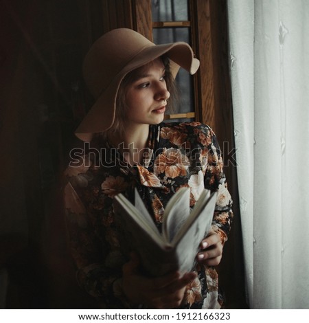 young girl at home with hat