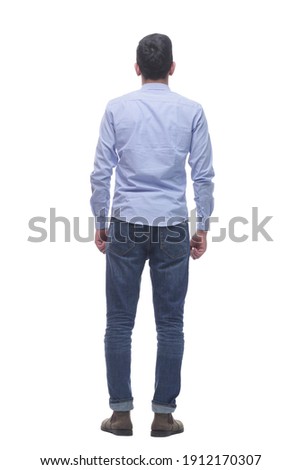 rear view . a young man in jeans looking at a white screen. Royalty-Free Stock Photo #1912170307