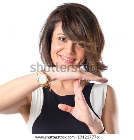 Pretty woman making time out gesture over white background 