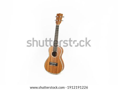 Brown ukulele isolated on white background, handmade.  Royalty-Free Stock Photo #1912191226