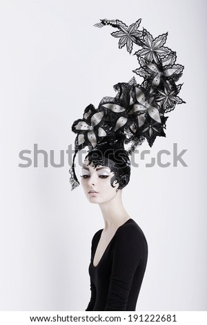 Creative Concept. Portrait of Futuristic Woman in Art Fabulous Headdress
