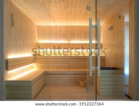 Front view of empty Finnish sauna room. Modern interior of wooden spa cabin with dry steam Royalty-Free Stock Photo #1912227364