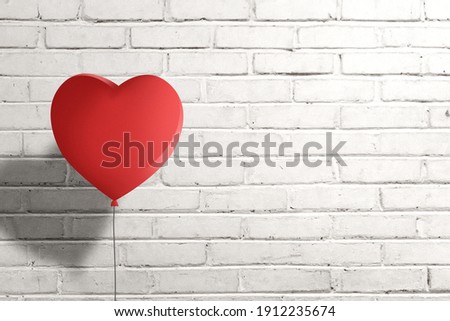 Heart balloon with brick wall background. Valentines day