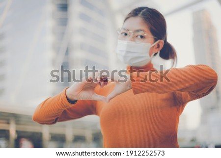 Woman making hands in heart shape, heart health insurance,social responsibility, donation, happy charity volunteer, world heart day, world mental health, cancer day, Valentines day