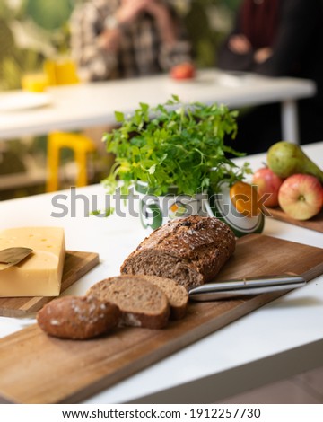 Happy family and friend gathering dining table, healthy food, having fun during a lunch or snacks, Apple and green vegetable also bread and cheese, bread with raisins, Family and friends eating lunch 