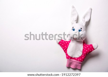 Banner with Easter bunny isolated on white background with copy space, empty text place. Education toy theater online course. Hand puppet. Sewing hobby. Fairy tale character. Fluffy baby play friend.