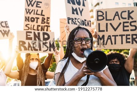 Activist movement protesting against racism and fighting for equality - Demonstrators from different age and race manifesting for equal rights - Black lives matter street city protests concept