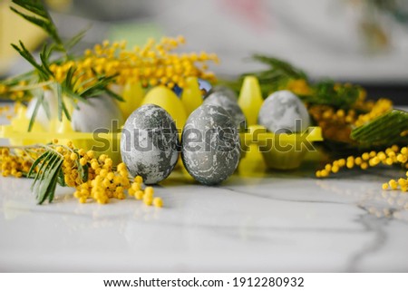 Happy Easter. Marble Eggs Mimosa on the Kitchen Table. Design and traditional decoration for the Holiday