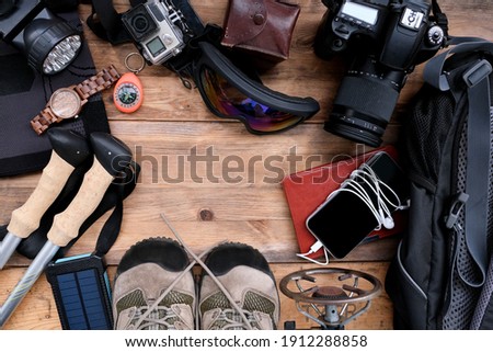 smartphone, watch, trekking boots, camera, top view, set of backpacker, concept of traveling around the world, active lifestyle