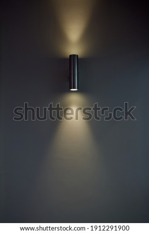An uplight downlight illuminating a wall. Royalty-Free Stock Photo #1912291900