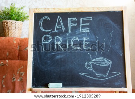 slate chalk board with the words "cafe price"