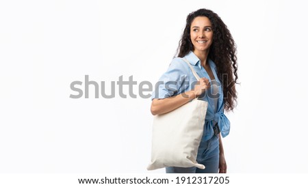 No Plastic. Happy Woman Carrying Flax Eco Bag Posing Looking Aside On White Studio Background. Eco-Friendly Shopping, No Plastic Life, Ecology Concept. Panorama With Copy Space