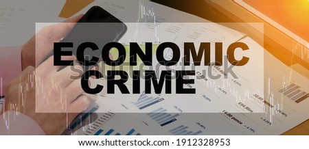 ECONOMIC CRIME - financial text on the background of a banner with a man at the computer