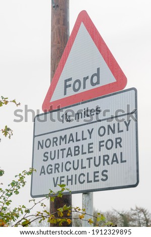 Roadside for a ford, with accompanying sign warning that it is "normally only suitable for agricultural vehicles"