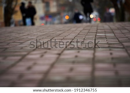 paving slabs photo close up with people's feet