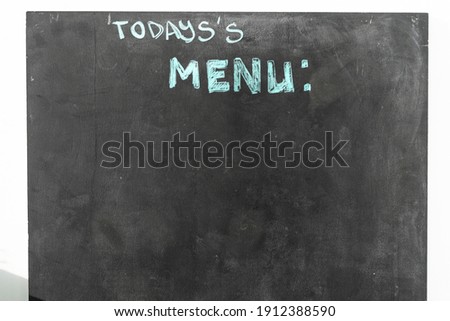 black chalkboard with menu text in the street restaurant