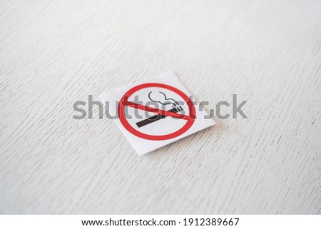 no smoking restriction sticker symbol area on the wall in public place 