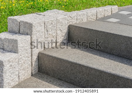Modern stone staircase in dark gray and light gray granite steles Royalty-Free Stock Photo #1912405891
