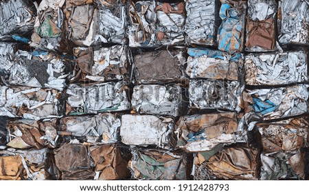 Scrap metal pressed into cubes for recycling, top view. Royalty-Free Stock Photo #1912428793
