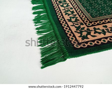 green prayer mat on the white floor