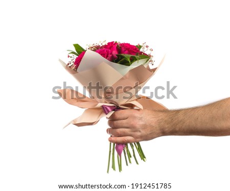 a man holds out a bouquet of flowers. holidays birthdays and weddings. isolated on white. copy space.