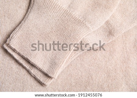 Warm cashmere sweater as background, top view Royalty-Free Stock Photo #1912455076