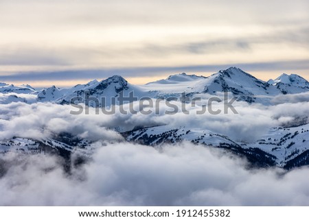 Whistler, British Columbia, Canada. Beautiful View of the Canadian Snow Covered Mountain Landscape during a cloudy and vibrant winter day. Royalty-Free Stock Photo #1912455382