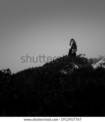 A young girl tourist taking a smartphone picture in a Ocean Cliff, Vicentine Coast, Alentejo, Portugal.